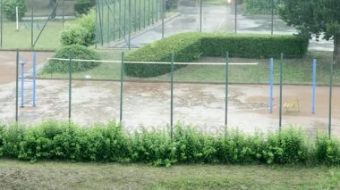 Açık Tenis veya Voleybol sahası ve boş Bahçesi üzerine ağır yağmur 