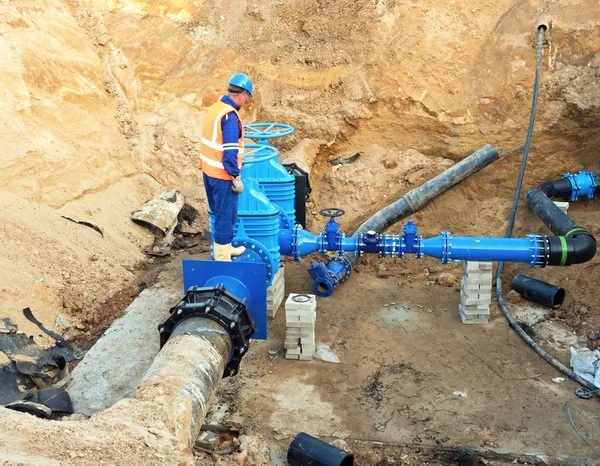 Trabajador subterráneo para reconstruir el sistema de agua potable. Experto técnico en válvula de compuerta — Foto de Stock