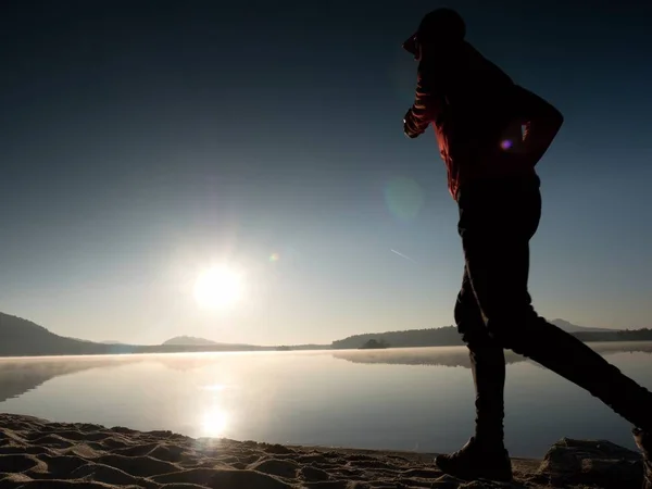 Running man. Boy quickly running on the morning beach. Sportsman runner, jogging guy