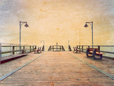 Film effect. Autumn misty morning on wooden pier above sea. Depression, dark  atmosphere. Touristic mole, wet wooden floor above sea.  clipart