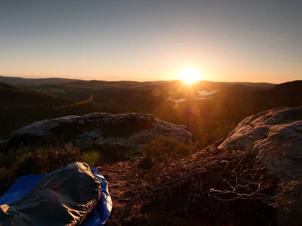 Beautiful awakening in  rocks.  Sleeping in nature in sleeping bag. View from rocky peak