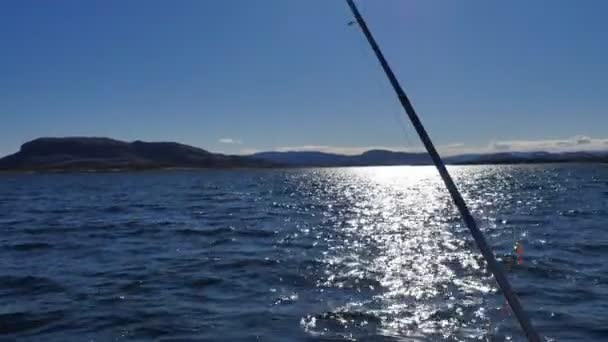 Surface de l'eau pétillante et canne à pêche mobile — Video