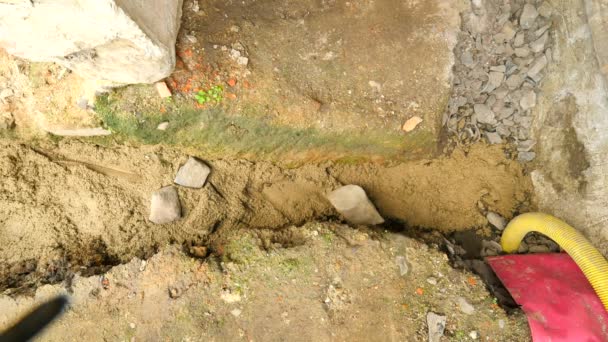 Verter, poniendo hormigón en los cimientos de la casa utilizando pala de cemento y piedras. Edificio, trabajo de hormigón en base. Alineación de la solera de hormigón. Verter cemento en la zanja del suelo . — Vídeos de Stock