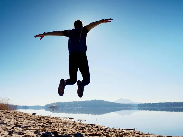 Adam atlama. Sporcu deli atlama ve kumsalda gündoğumu sırasında koşu