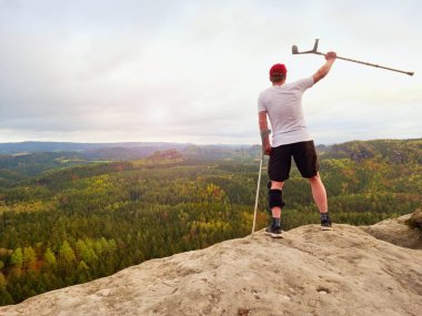 Diz eklem bandaj ve önkol Polonyalılar ile fiyatı. Uzun yürüyüşe çıkan kimse cliff üzerinde zafer jest yapar.