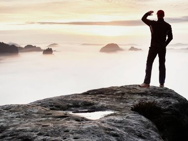 Siluet Polonyalılar ile el dostum. Güneşli Bahar şafak ve turist kılavuz kalış Dağı'nın keskin cliff üzerinde.