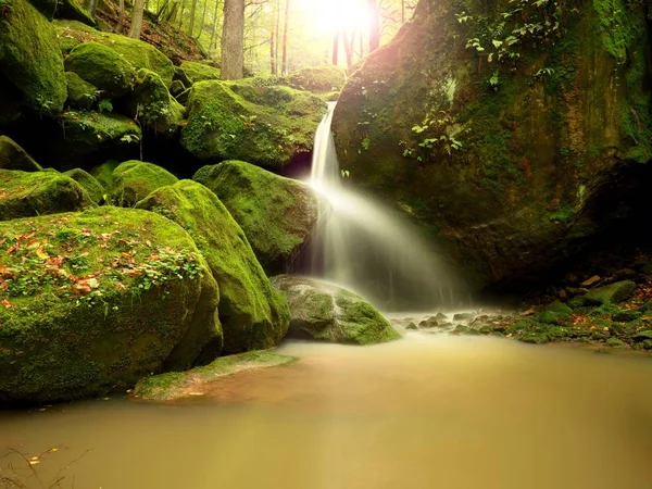 Rapids on small mountain stream between mossy  basalt rocks. Blurred water running over stones — Stock Photo, Image