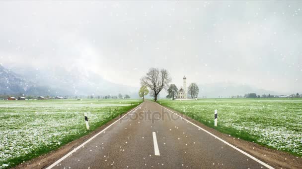 La Iglesia de San Colomán mientras nieva. El paisaje invernal, Schwangau, Alemania. Montañas nevadas en el fondo — Vídeo de stock