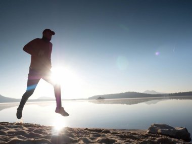 Adam güneş gözlüğü, Kırmızı beysbol şapkası ve siyah spor giyim çalışan ve kumsalda egzersiz kırmızı.