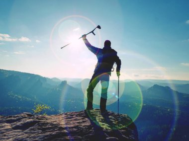 Turist izinde başının üstünde ön kol koltuk değneği ile. Uzun yürüyüşe çıkan kimse elde dağ tepe zarar