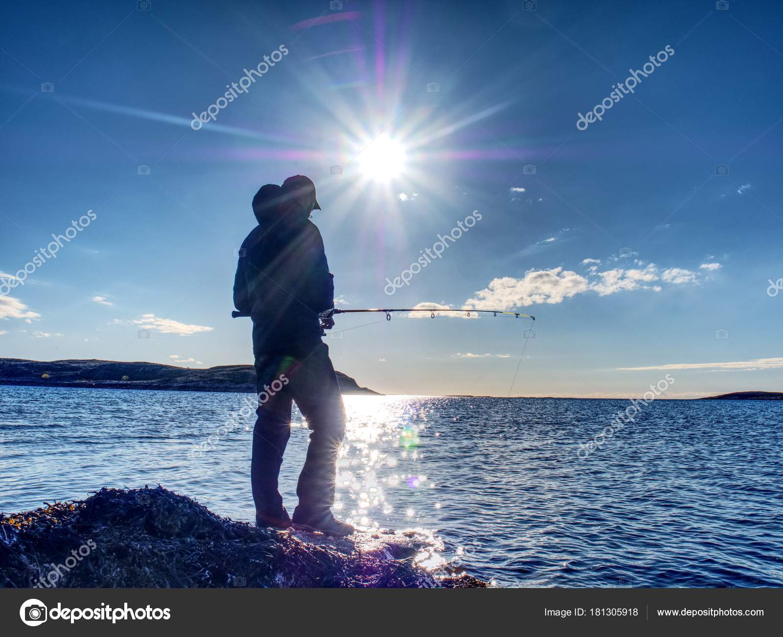 Fisherman silhouette at sunset Fisherman check fishing line and