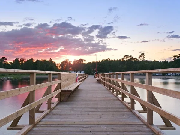 Long wooden pier on the Baltic coast during morning. Cold weather, cold water. New built