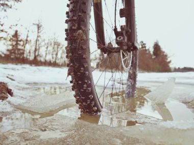 Ivy Havuzu, kış manzarası içinde Bisiklete binme aşırı bloke mtb ön tekerlek. Kırık buz parçası