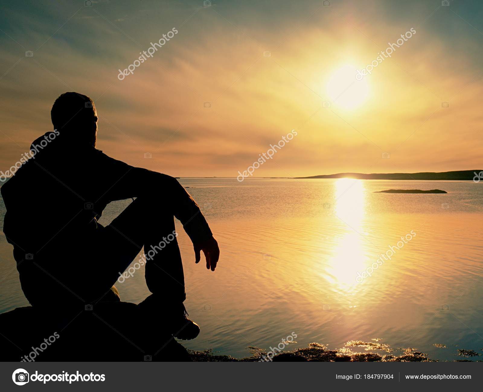 Lonely Man Hiker Sits Alone On Coast And Enjoying Sunset View Over Rocky Cliff To Ocean Stock Photo Image By C Rdonar Lonely Man Hiker Sits Alone On Coast And Enjoying Sunset View Over Rocky Cliff To Ocean Stock Photo Image By C Rdonar