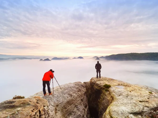 Fotografar na natureza selvagem. Fotógrafo de natureza com câmera grande no tripé ficar na rocha do cume. Ouça a musa — Fotografia de Stock
