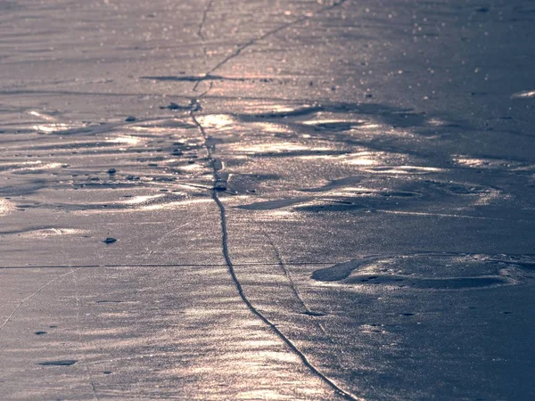 Trozos de hielo agrietado sobresalen en el lago congelado. El fenómeno de la luz ocurre — Foto de Stock