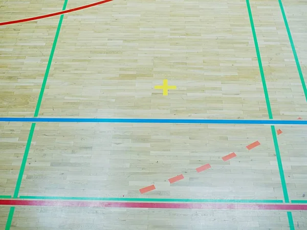 Green shadows of shining floor of sports hall with marking lines