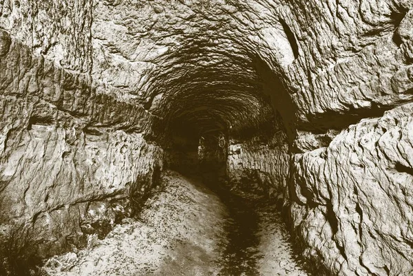 The old water tunnel, mined caves.  The cave. Sandstone tunnel moistened walls. — Stock Photo, Image