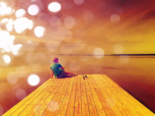 Soyut etkisi. Küçük sarı saçlı çocuk ahşap köstebek sonunda balık tutuyor. Bay yumuşak su seviyesi