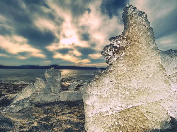 Glace fondante sur une plage de sable fin. Détail de la banquise avec fissures profondes à l'intérieur — Photo