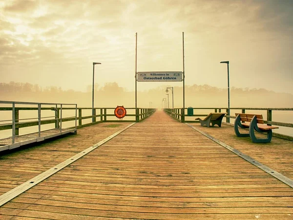 Nebbia crepuscolo sul molo di pesca punto di riferimento, ringhiere molo. Talpa di legno — Foto Stock