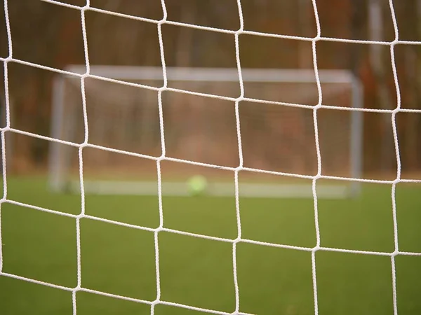 Fotbollsspelare står mot målet med net och stadium. Fotboll gate netto. Fotboll gate — Stockfoto