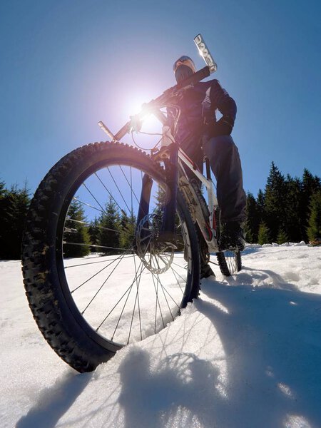 Широкий вид фото горного велосипеда в глубоком снегу. Зимние горы с дорогой, затерянной под снегом
.