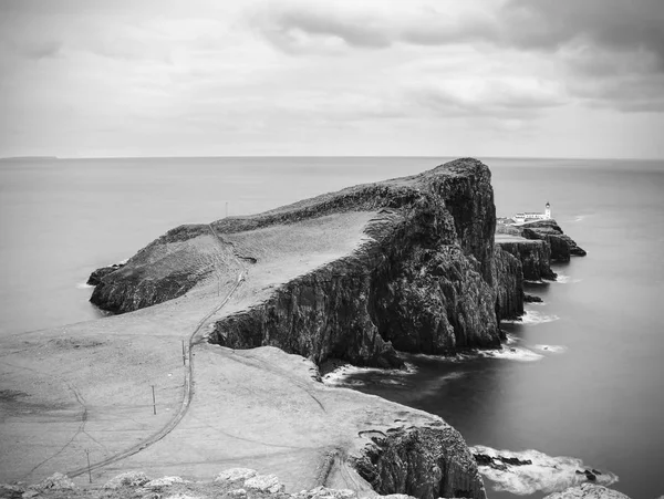 Cliffs of Neist Point Cape and lighthouse in black and white. — Stock Photo, Image