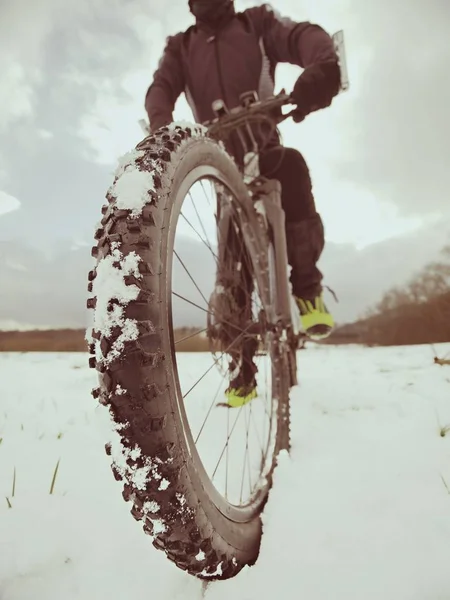 Homem ciclista com bicicleta de inverno fica na neve. Inverno conceito esportivo extremo . — Fotografia de Stock