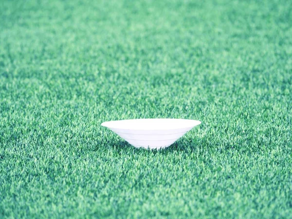 Training cone for football on a green field. Artificial green turf — Stock Photo, Image