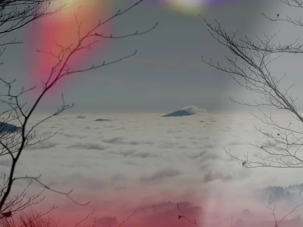 Dreamy misty landscape above the sea of clouds, town in mist — Stock Photo, Image