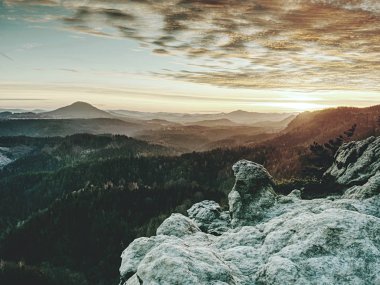 Tepeler siluetleri ve sis parlak arka ışık ile vadiler dolu.