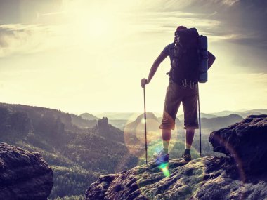 Man with backpack and hiking poles. Danger place a clipart