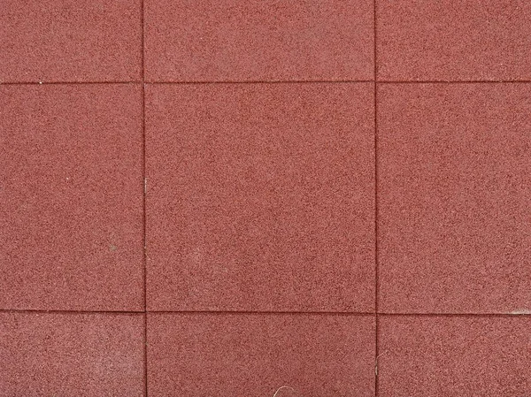 Texture of red rubber floor used for safety kids playground