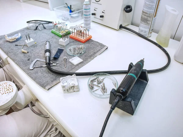 Precision of Metal-ceramic crown. Dental technician is working