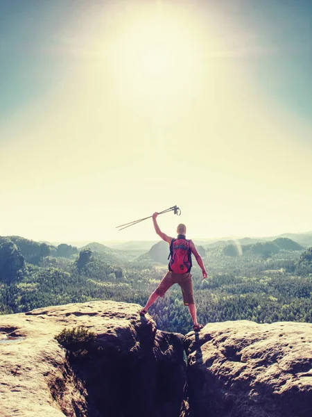 Man hiker raised arm with stick. Happy tourist guide on peak — Stock Photo, Image