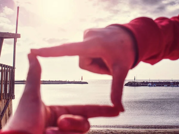 Girl hands capture piuer with lighthouse at sea. — 스톡 사진