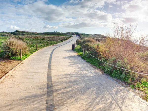 Stony tilled paved footpath at sea, dark stripe — Stock Photo, Image