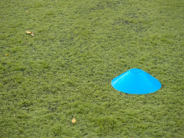 Selective focus to cones on green artificial turf without players — Stock Photo, Image