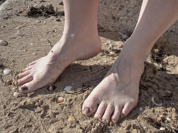 Mulher andando e brincar com conchas na praia — Fotografia de Stock