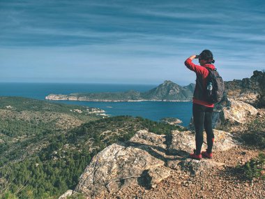 Gezgin kadın, dağdaki tek patika mavi deniz koyunu izlerken gözlerini gölgede bırakıyor.