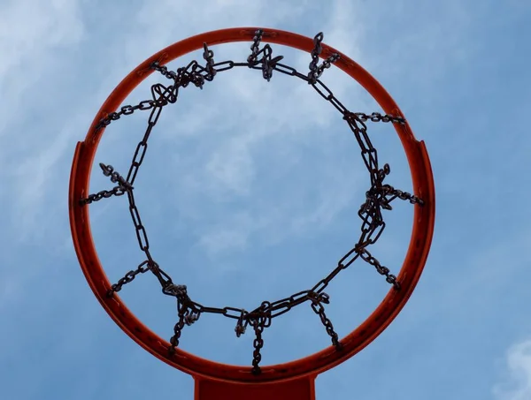 Baskerball hoop. Worn out basketball hoop on basketball court under sky