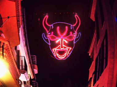 Devilish decoration  in Palma city during saint sebastian local patron festivities. clipart