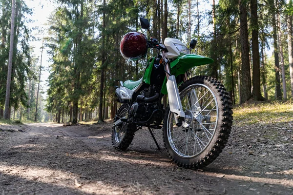Enduro motorcycle parked in the forest, IRBIS TTR, concept, active lifestyle, enduro, off-road, the rays of the sun, background for the screen