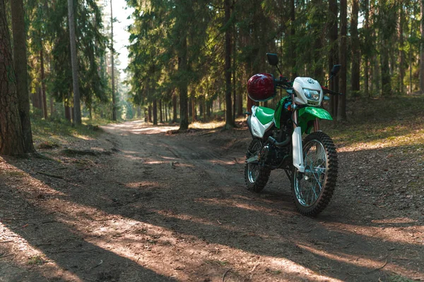 Enduro motorcycle parked in the forest, IRBIS TTR, concept, active lifestyle, enduro, off-road, the rays of the sun, background for the screen