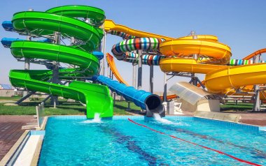 Aquapark sürgüleri ve parkta havuz.