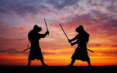 Silhouette of two samurais in duel.  clipart
