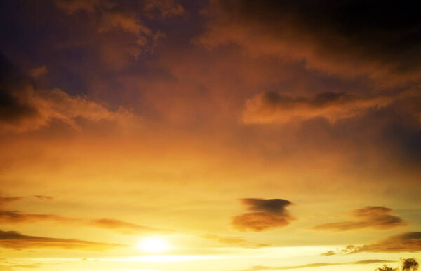 Beautiful stormy sunset sky. Cloudy abstract background. Sunset colors.