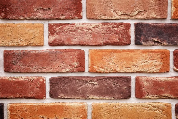 Arka plan olarak tuğla duvar. Çok renkli Tuğlalar