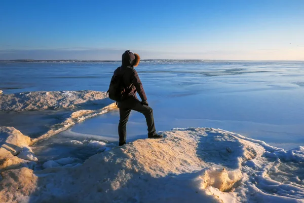 Man on the frozen river during sunset. — Stock Photo, Image